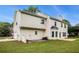 Exterior view of the back of the home with large windows, a patio, and a grassy backyard at 602 Jules Crest Ct, Lawrenceville, GA 30045