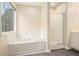 Bathroom features stand up shower, and soaking tub with tile surround at 602 Jules Crest Ct, Lawrenceville, GA 30045