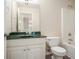 A functional bathroom with white cabinetry and green counters alongside essential fixtures at 602 Jules Crest Ct, Lawrenceville, GA 30045