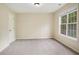 A simple carpeted bedroom bathed in natural light with a closed white door at 602 Jules Crest Ct, Lawrenceville, GA 30045