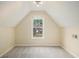 Bright bedroom with a large window offering a view of the house across the street at 602 Jules Crest Ct, Lawrenceville, GA 30045