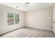This bright bedroom has a window with natural lighting, neutral paint, and carpeted floor at 602 Jules Crest Ct, Lawrenceville, GA 30045