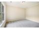 A sunlit, carpeted bedroom with large window perfect for a simple minimalist design at 602 Jules Crest Ct, Lawrenceville, GA 30045