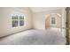 Spacious carpeted bedroom featuring a large window for natural light and an attached bonus room at 602 Jules Crest Ct, Lawrenceville, GA 30045