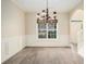 Elegant dining room with wainscoting, wood floors, decorative chandelier, and sunlit window at 602 Jules Crest Ct, Lawrenceville, GA 30045