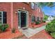 Close-up of the front entrance featuring a black door, brick facade, and manicured landscaping at 602 Jules Crest Ct, Lawrenceville, GA 30045
