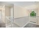 Upstairs hallway with staircase, carpet and a skylight provides natural light at 602 Jules Crest Ct, Lawrenceville, GA 30045