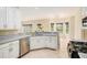 Well-lit kitchen features stainless appliances, granite countertops, and a sunny breakfast nook at 602 Jules Crest Ct, Lawrenceville, GA 30045