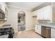 Modern kitchen with granite countertops, stainless steel appliances, and tile flooring at 602 Jules Crest Ct, Lawrenceville, GA 30045