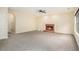 Open living room with fireplace, ceiling fan, and large windows, leading to other rooms at 602 Jules Crest Ct, Lawrenceville, GA 30045