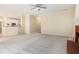 Open-concept living room flowing into the kitchen, featuring plush carpet and a cozy fireplace at 602 Jules Crest Ct, Lawrenceville, GA 30045