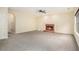 Large living room featuring a brick fireplace, neutral walls, and plush carpet at 602 Jules Crest Ct, Lawrenceville, GA 30045