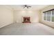 Spacious living room with plush carpeting, a fireplace, ceiling fan, and large window at 602 Jules Crest Ct, Lawrenceville, GA 30045