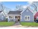 Charming blue one-story home featuring a welcoming front porch and well-maintained lawn at 1087 Longley Nw Ave, Atlanta, GA 30318