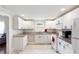 The kitchen features all white cabinets and granite countertops, and stainless appliances for a modern look at 1087 Longley Nw Ave, Atlanta, GA 30318
