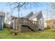 Backyard view of a home showcasing its deck with wooden stairs and landscaped yard at 1091 Longley Nw Ave, Atlanta, GA 30318