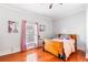 Bright bedroom with a wood bed frame, pink accents, and views of the outdoors at 1091 Longley Nw Ave, Atlanta, GA 30318