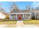 Charming gray home with a welcoming front porch and bright red front door at 1091 Longley Nw Ave, Atlanta, GA 30318