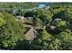 Aerial view of a home surrounded by trees, other homes, and a lake with boat docks at 1875 Bernice Dr, Cumming, GA 30041