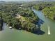 Lake houses surrounded by luscious green trees sit on the water near a lake marina at 1875 Bernice Dr, Cumming, GA 30041