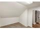 Cozy attic space with neutral carpet and an entrance to an updated bathroom with shower at 1875 Bernice Dr, Cumming, GA 30041