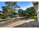 Back deck of a house with wooden railing overlooking a large tree and the neighborhood at 1875 Bernice Dr, Cumming, GA 30041