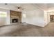 Carpeted basement area with a decorative brick fireplace and a hallway at 1875 Bernice Dr, Cumming, GA 30041