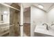 Modern bathroom with glass shower door, white vanity, and view into bedroom at 1875 Bernice Dr, Cumming, GA 30041