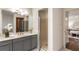 Stylish bathroom with gray cabinets, a walk-in shower, and modern fixtures at 1875 Bernice Dr, Cumming, GA 30041