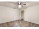 Comfortable carpeted bedroom with a ceiling fan, natural light, and a closet, creating a cozy retreat at 1875 Bernice Dr, Cumming, GA 30041