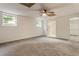 Spacious carpeted bedroom with ceiling fan and natural light, offering a comfortable and inviting space at 1875 Bernice Dr, Cumming, GA 30041