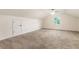Bright bedroom featuring neutral carpet and paint with a window and closet door at 1875 Bernice Dr, Cumming, GA 30041