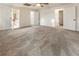 Spacious carpeted bedroom with ceiling fan and open doorways to a closet and bathroom at 1875 Bernice Dr, Cumming, GA 30041