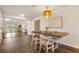 Spacious dining area features hardwood floors, a modern light fixture, and adjacent access to the living room at 1875 Bernice Dr, Cumming, GA 30041
