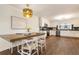 Dining area with decorative light fixture is adjacent to the kitchen with stainless steel appliances at 1875 Bernice Dr, Cumming, GA 30041