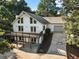 Stunning exterior view of a lake house with a spacious deck and attached garage on a sunny day at 1875 Bernice Dr, Cumming, GA 30041