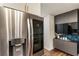Modern kitchen with stainless steel refrigerator and black cabinets at 1875 Bernice Dr, Cumming, GA 30041