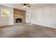 Carpeted living room with a decorative fireplace and two windows for natural light at 1875 Bernice Dr, Cumming, GA 30041