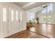 Living room featuring hardwood floors, vaulted ceilings, stylish furniture, and french door to outdoor deck at 1875 Bernice Dr, Cumming, GA 30041