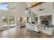 Beautiful living room with stone fireplace, high ceilings, wood beams, and outdoor deck access at 1875 Bernice Dr, Cumming, GA 30041