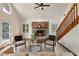 Bright living room featuring a stone fireplace, hardwood floors, and high ceilings with exposed beams at 1875 Bernice Dr, Cumming, GA 30041