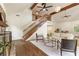 Bright living room features vaulted ceilings, exposed beams, a fireplace, a staircase, and hardwood floors at 1875 Bernice Dr, Cumming, GA 30041