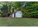 Backyard image of a detached single-car garage with side shed and lawn at 1875 Bernice Dr, Cumming, GA 30041