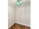 Empty room with wood floors and a decorative ceiling light at 1875 Bernice Dr, Cumming, GA 30041