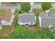 Aerial view of home showcasing well-maintained yard, shed, mature trees, and neighborhood at 3060 Baymount Dr, Lawrenceville, GA 30043