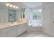 Bright bathroom with double vanity, large tub, shower, and natural light at 3060 Baymount Dr, Lawrenceville, GA 30043