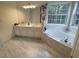 Bright bathroom with double vanity, large tub, and natural light at 3060 Baymount Dr, Lawrenceville, GA 30043