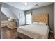 Bedroom features wood floors, gray walls, a dresser with a fish tank, and a tufted headboard at 3060 Baymount Dr, Lawrenceville, GA 30043