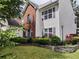 Charming two-story home with brick and white siding, complemented by a well-maintained lawn and colorful flower beds at 3060 Baymount Dr, Lawrenceville, GA 30043