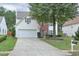 Inviting two-story home features a two-car garage, brick facade, and mature trees in a well-manicured front yard at 3060 Baymount Dr, Lawrenceville, GA 30043